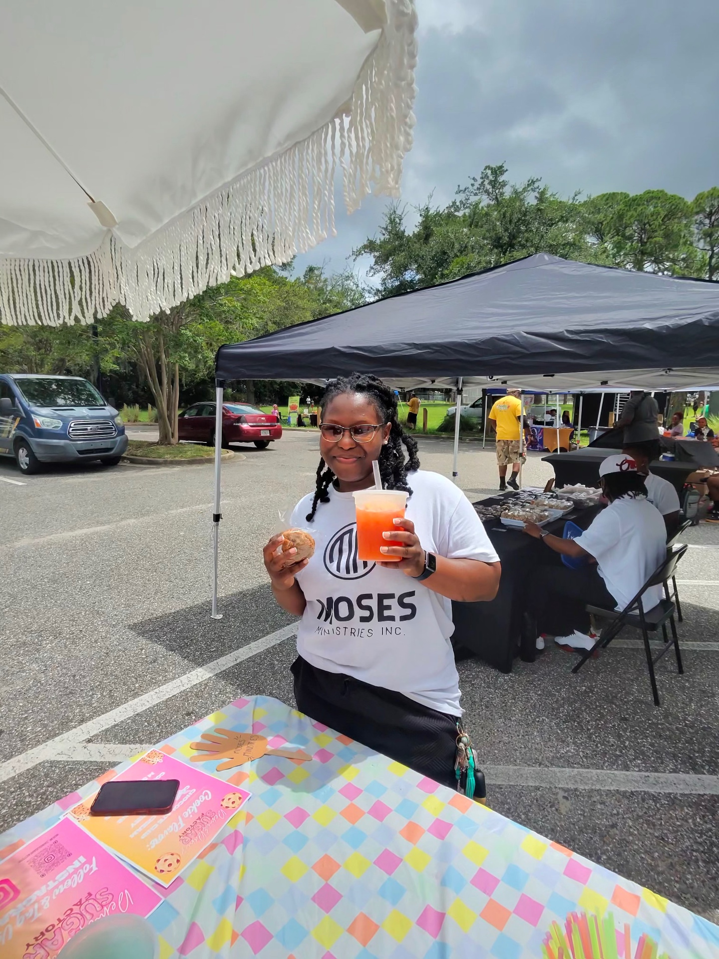 Customer enjoying a fresh cookie and gourmet lemonade at the Sugar Factory booth